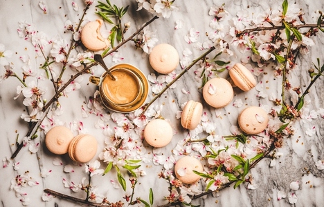Flat lay of espresso coffee  macaron cookies and flowers