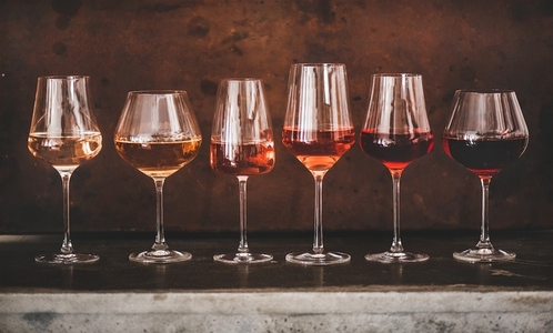 Shades of Rose wine in glasses with rusty background