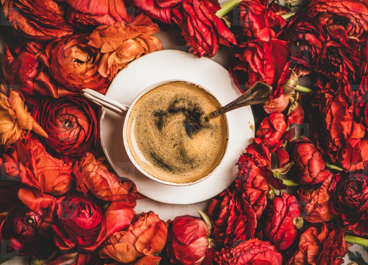 Black espresso coffee in white cup on red flower background