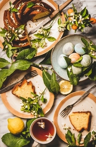 Easter table setting with colorful eggs and citrus cake