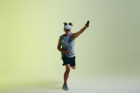 Senior man winning a virtual fitness game