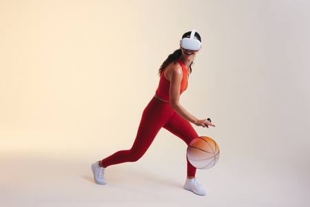 Woman playing basket ball in virtual reality