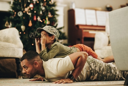 Military dad spending quality time with his son at Christmas