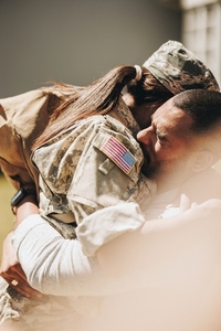 Female soldier reuniting with her husband at home