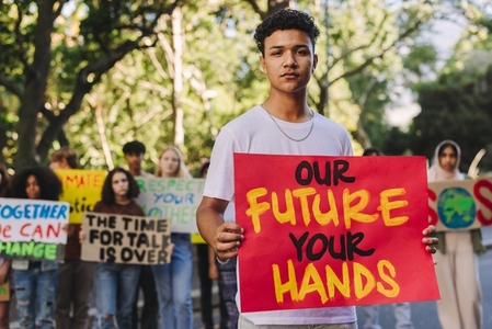 Teenage boy leading a march against climate change