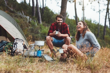 Young couple having a good time while camping
