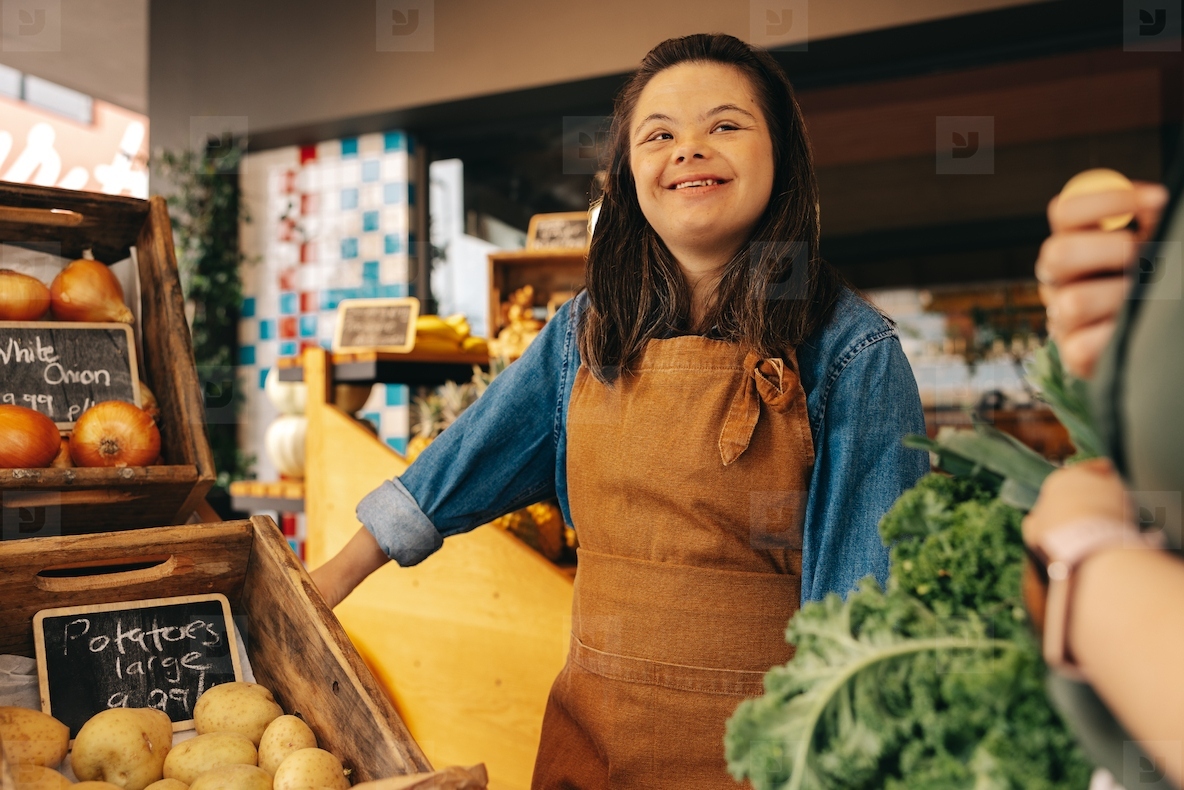 Happy woman with Down syndrome assisting a customer in a grocery store
