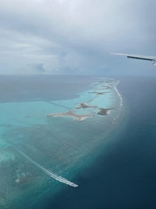 View from airplane on an ocean and big coral reef