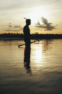 Spear fisherman going fishing at sunset