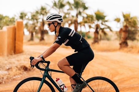 Side view of professional female cyclist riding her bike