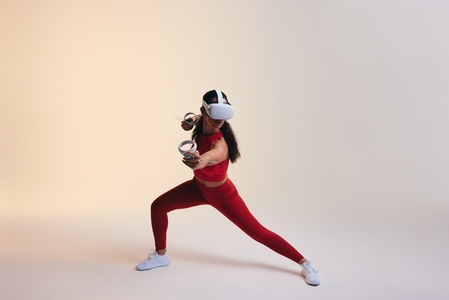 Sportswoman playing a virtual reality fitness game