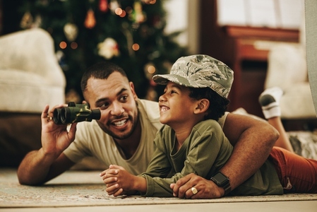 Happy military dad spending quality time with his son at Christmas