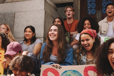 Happy youth activists holding a climate change demonstration