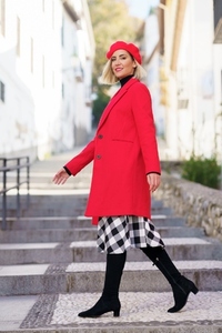 Stylish woman in coat walking on steps