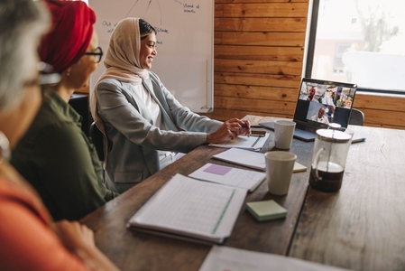 Diverse female entrepreneurs attending an online meeting