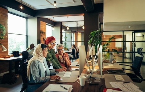 Group of ethnic businesswomen working together in a coworking office