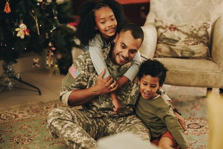 Cherful military family spending Christmas together at home