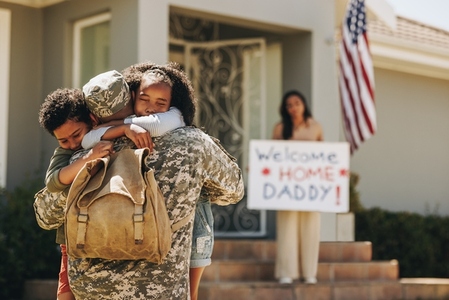 Two young children reuniting with their military father
