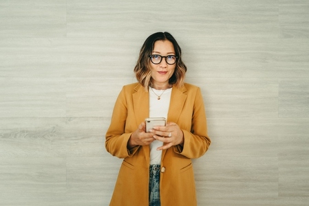 Modern businesswoman using a smartphone in an office