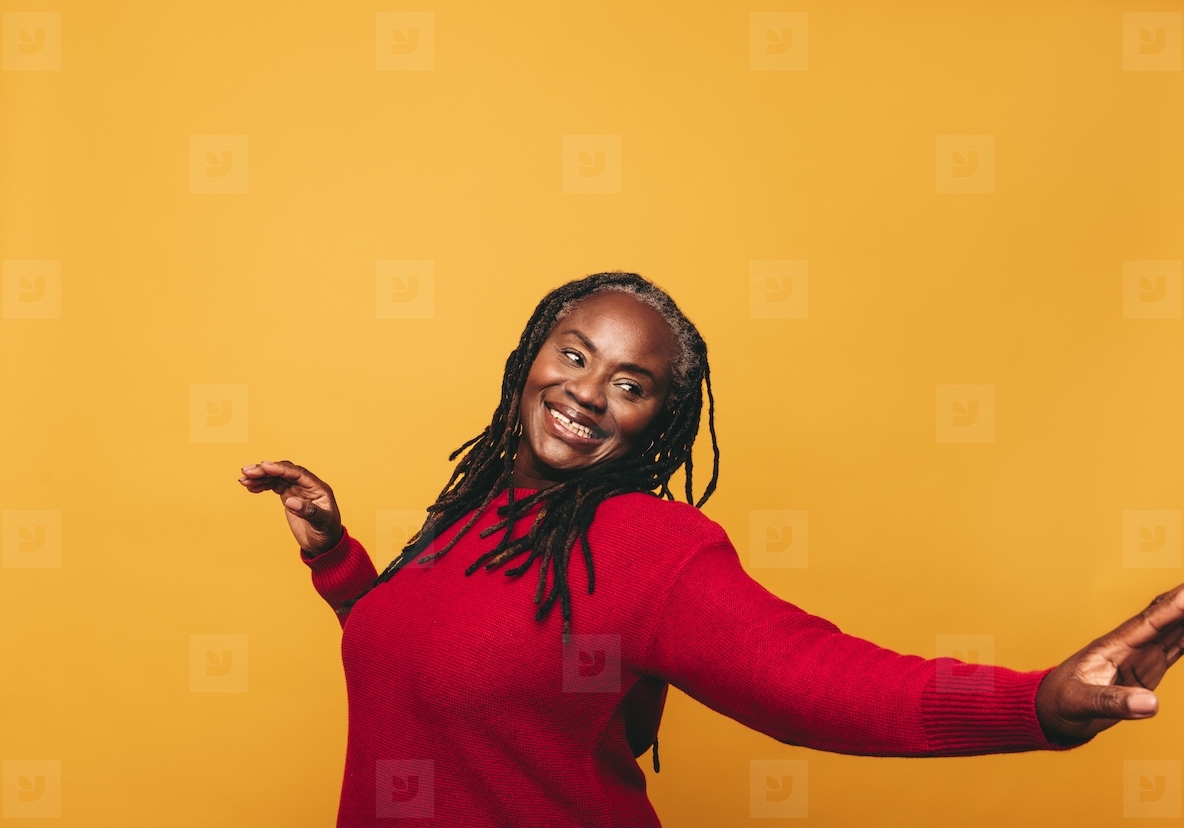 Cheerful black woman dancing in a studio