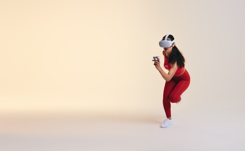 Fit young woman working out in virtual reality