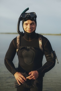 Happy young man looking at the camera in a scuba gear
