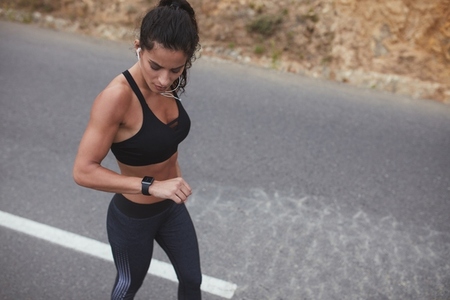 Fit young woman checking her progress on a smartwatch