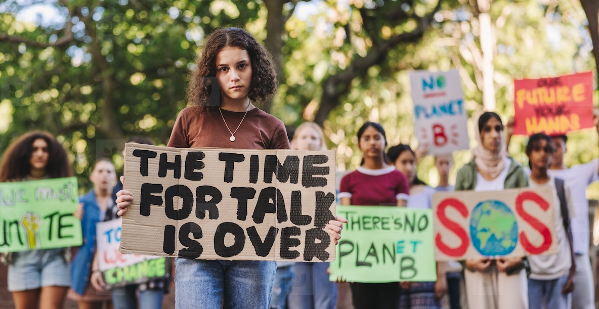 Teenage girl leading a march against climate change