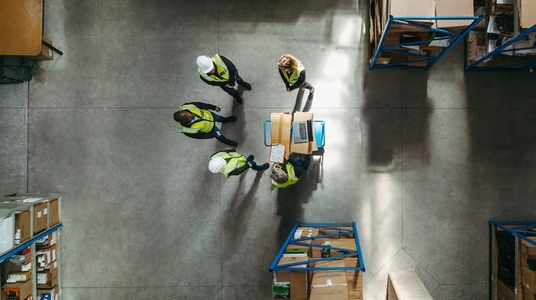 Top view of a warehouse team having a staff meeting