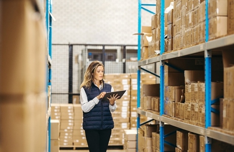 Woman taking stock using a digital tablet in a warehouse