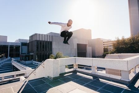 Athletic man practicing parkour tricking and freerunning