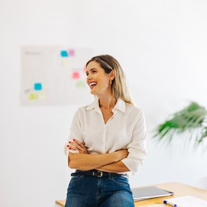 Creative businesswoman smiling cheerfully in a modern office