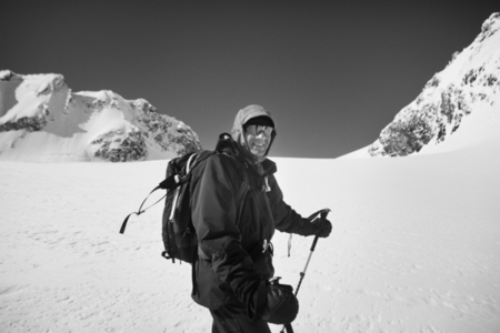 Portrait smiling senior male mountain climber on snowy mountain