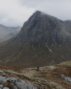 Man hiking in scenic autumn Scottish Highlands