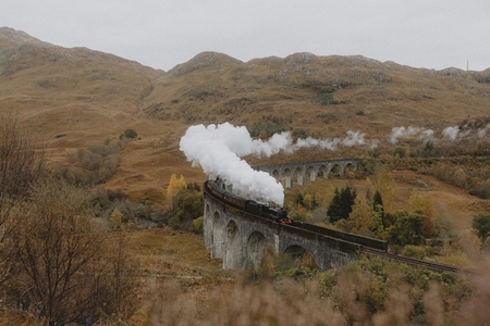 Steam emitting from train on Glenfinnan Viaduct in autumn Scottish Highlands