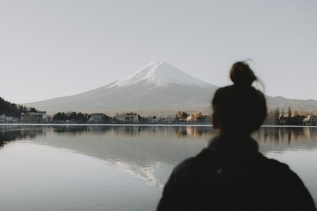 Woman looking at sunny scenic view Mount Fuji