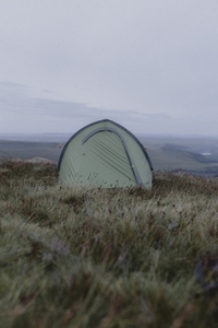 Camping tent on grassy hill