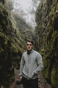 Portrait confident young male photographer exploring gorge