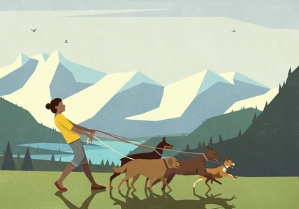Woman walking dogs on leashes in mountain landscape