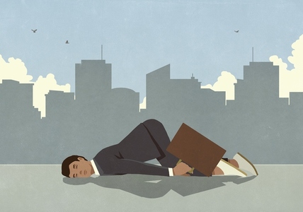 Exhausted businessman sleeping on city sidewalk