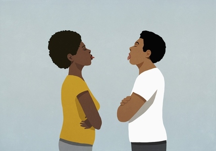 Couple standing face to face sticking tongues out