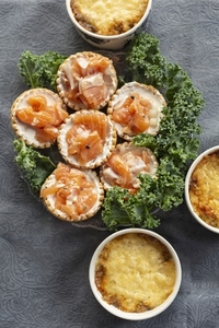 Still life view from above mini salmon tarts and cheese casserole