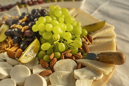 Close up cheese board with grapes and almonds