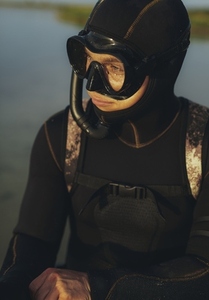 Young scuba diver looking away