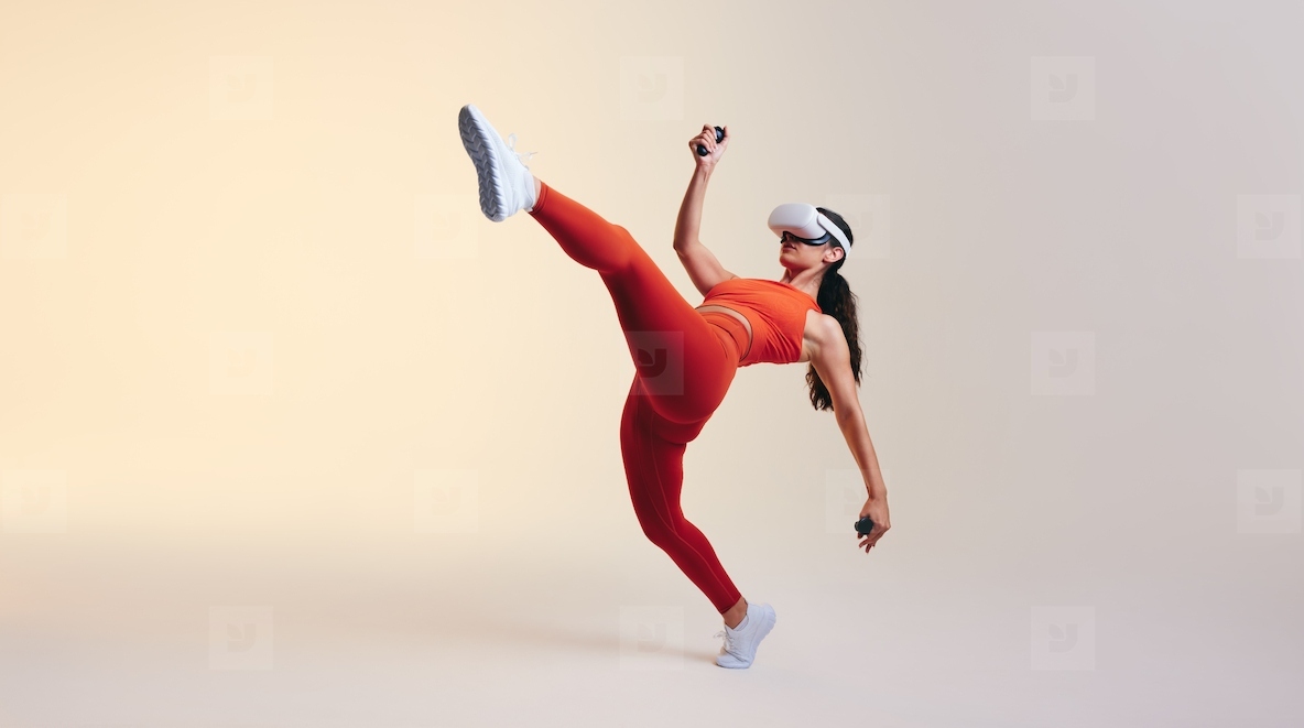 Sporty young woman doing fitness moves in virtual reality