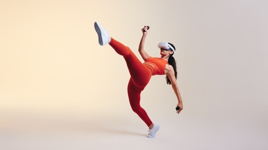 Sporty young woman doing fitness moves in virtual reality