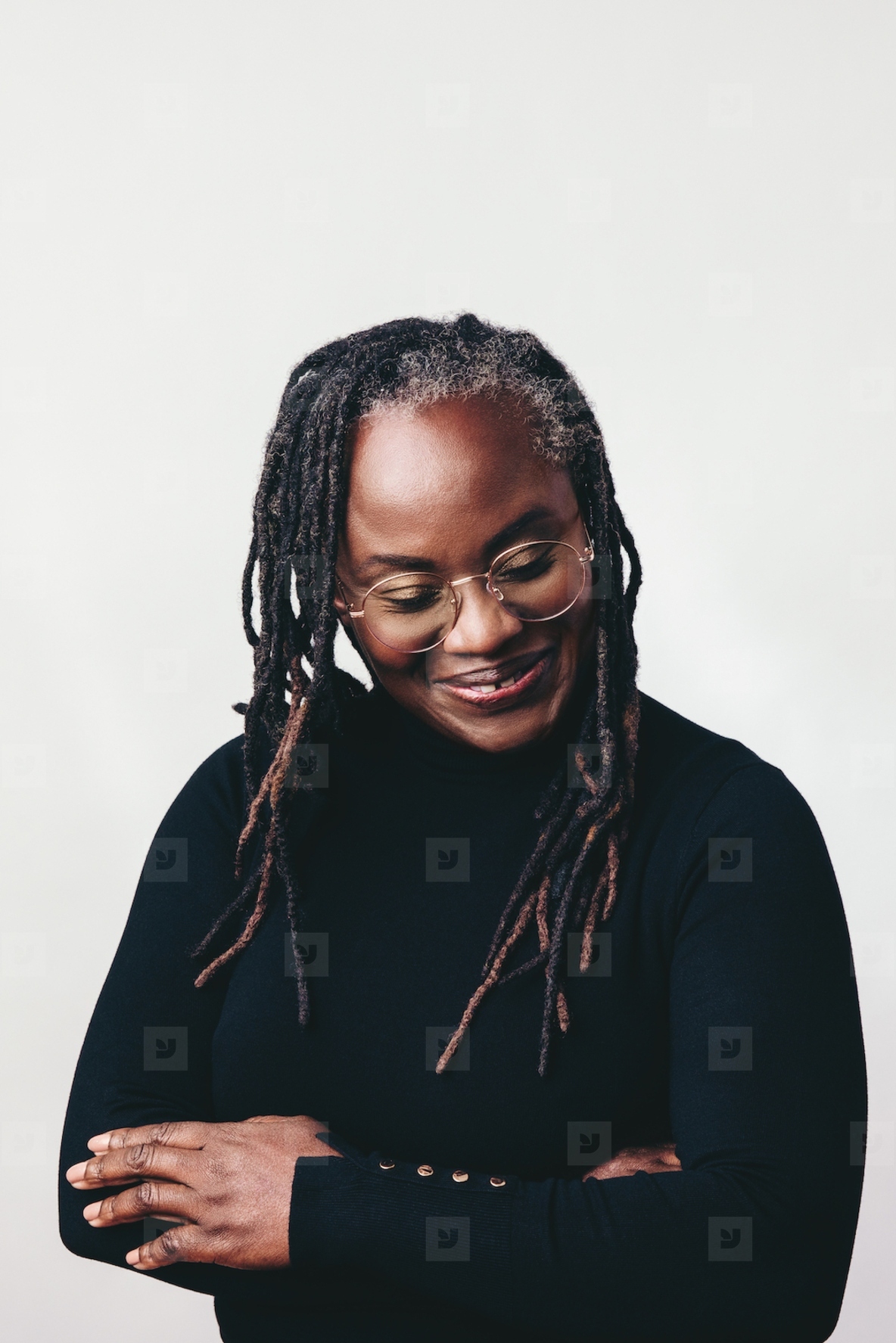 Professional woman with dreadlocks smiling happily in a studio