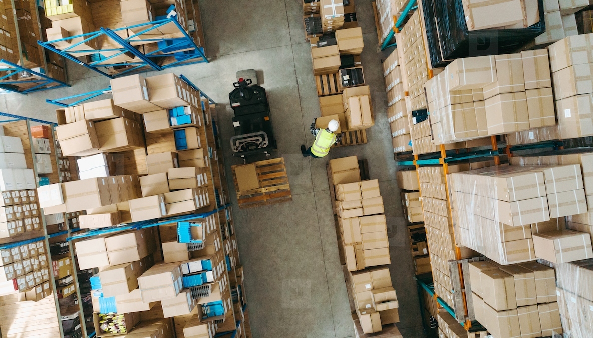 High angle view of a warehouse employee moving goods