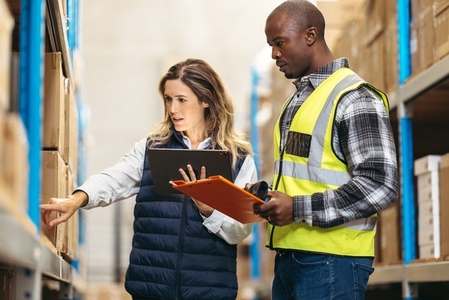 Two warehouse employees doing inventory control