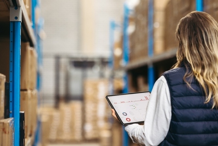 Logistics manager using a digital warehouse management system
